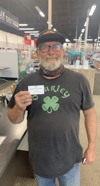 a man holding a check in a store